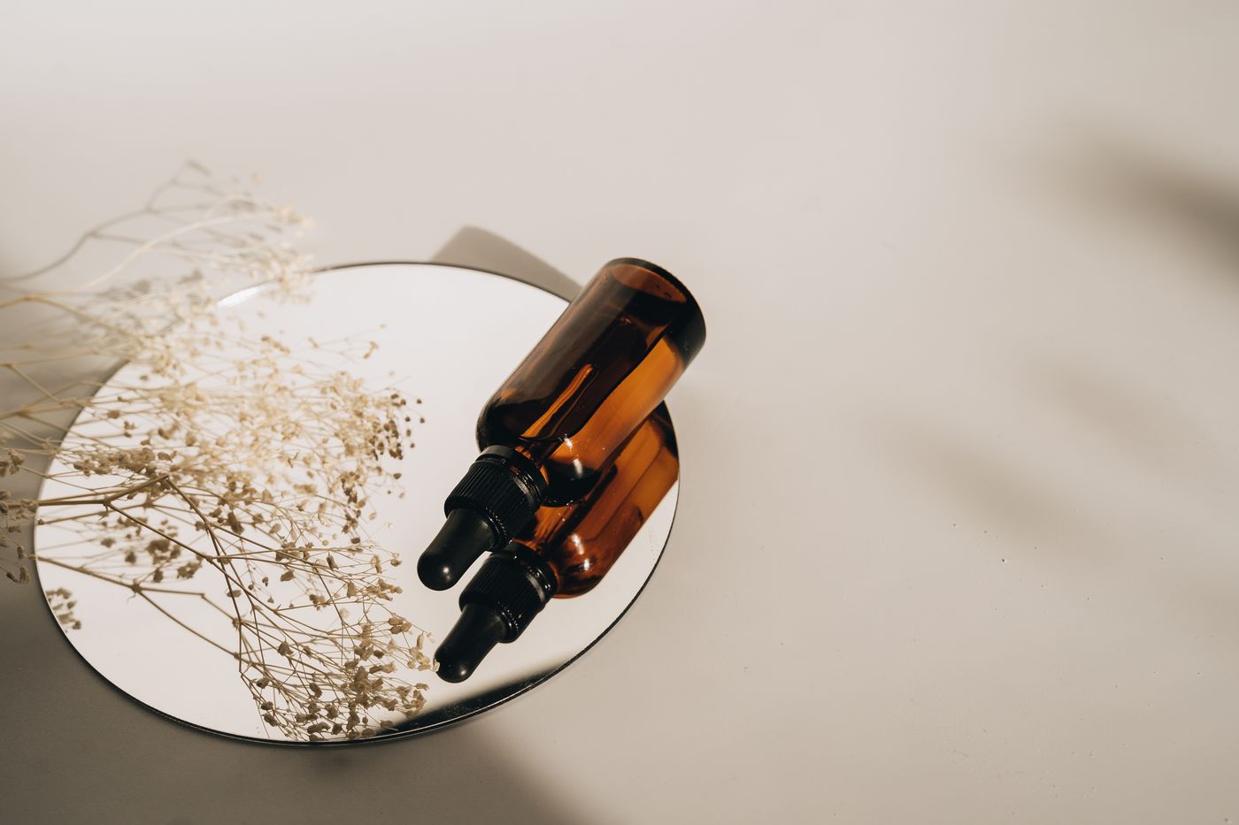 Amber glass dropper bottles with dried gypsophila